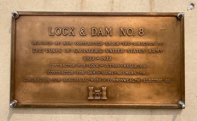 A plaque with constrution details is shown Wednesday, May 17, 2023 at Lock and Dam #8 in Genoa, Wis.  The locks allow the boats to gradually adjust to changing river levels. Most towboats can push 15 barges at a time on the river. When those barges reach a 600-foot long lock, they don’t fit. Instead, they have to be split up, which takes more than twice as long.It was constructed and was put into operation by April 1937.