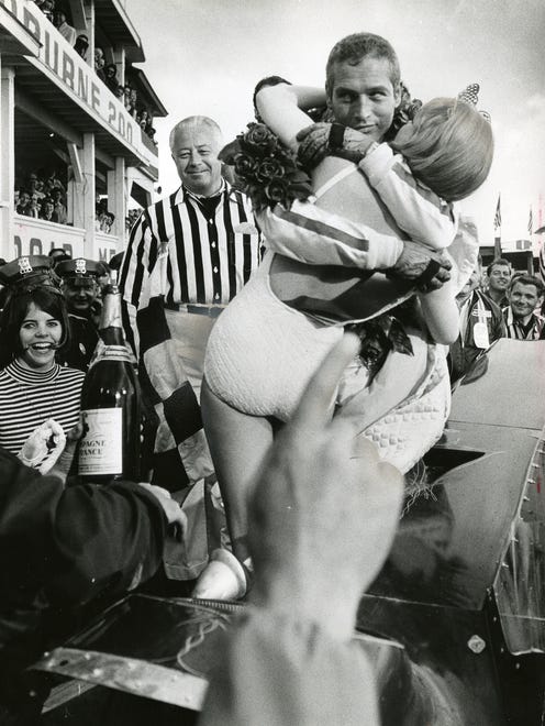 Paul Newman rehearses a scene in the winner's circle at Road America in Elkhart Lake during the filming of the movie "Winning" on May 20, 1968. The movie crew spent a week and a half filming in Wisconsin, most of it at Road America. Some biographers say Newman's love of auto racing got its start on the track at Elkhart Lake. This photo was published in the May 21, 1968, Milwaukee Journal.

1968 role in "Winning" sparked his interest in race car driving.  Paul Newman got a kiss from actress Eileen Wesson Monday as they rehearsed a scene from the movie " Winning" , a portion of which is being filmed at the Road America track in Elkhart Lake. The fingers in the foreground are those of director James Goldstone. SCAN FOR PAUL NEWMAN OBIT