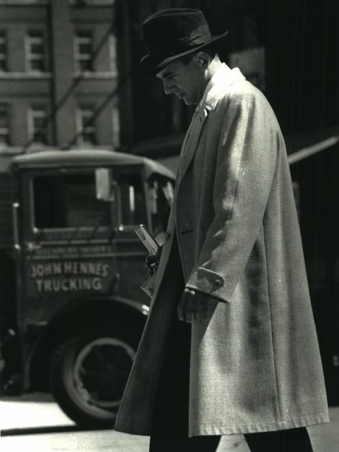 Mark Harmon walks off the set of the movie "Dillinger" with gun in hand after the filming of a bank robbery scene Sunday in the 200-300 block of N. Broadway in June 1990. The made-for-TV movie about Depression-era bank robber John Dillinger aired in 1991 on ABC.