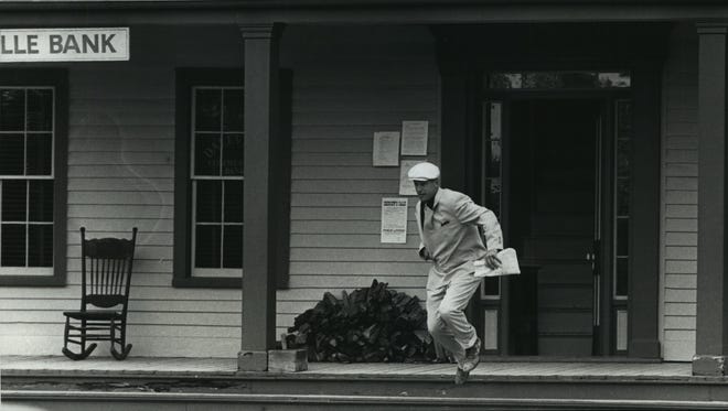 Mark Harmon portrays bank robber John Dillinger as he leaps from a recreated bank on a movie set at Old World Wisconsin in Eagle on May 24, 1990. This photo was published in the May 30, 1990, Milwaukee Journal.