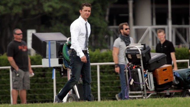 Shia LaBeouf walks across the set during the filming of a scene for "Transformers: Dark of the Moon" near the Milwaukee Art Museum on July 12, 2010. The movie, the third in the franchise, came out in 2011.