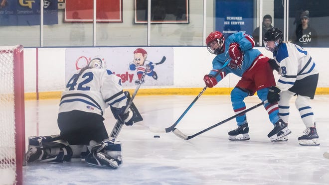 Arrowhead's Bella Hamel (5) takes a shot against Lakeshore Lightning goalie Elizabeth Bowers (42) during the game at the Ozaukee Ice Center in Mequon on Wednesday, Nov. 29, 2023.