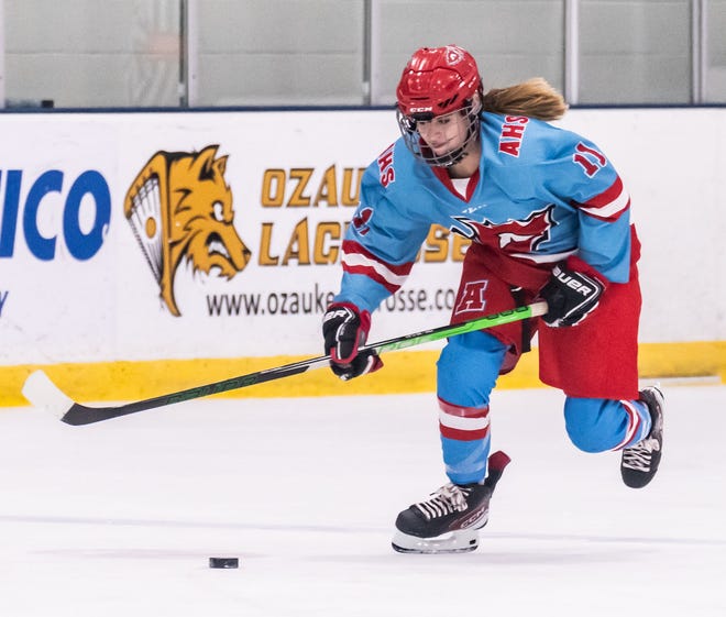 Arrowhead's Elizabeth Robinson (11) brings the puck down ice against the Lakeshore Lightning at the Ozaukee Ice Center in Mequon on Wednesday, Nov. 29, 2023.