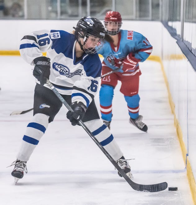 Lakeshore Lightning's Olivia Dykema (16) collects the puck during the game against Arrowhead at the Ozaukee Ice Center in Mequon on Wednesday, Nov. 29, 2023.