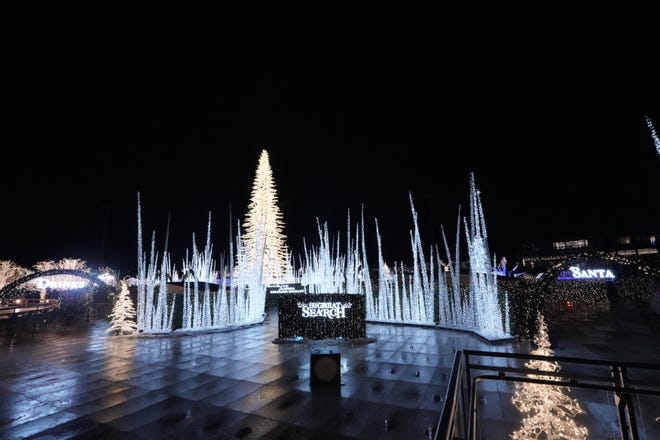 At the entrance to the Enchant Christmas light maze in Franklin, visitors learn their goal is to search for Santa's lost reindeer.