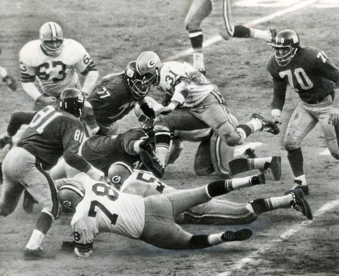 Jim Taylor of the Green Bay Packes carries the ball in the 1962 NFL Championship game against the New York Giants on Dec. 30, 1962, at Yankee Stadium in New York. The Packers won 16-7. Packers guard Jerry Kramer was the difference maker in the win, kicking three field goals.