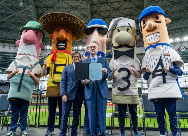 Milwaukee Brewers owner Mark Attanasio and Gov. Tony Evers snap a photo as Assembly Bill 438 and Assembly Bill 439 is signed, a bipartisan package of bills passed by the Wisconsin State Legislature to keep the Milwaukee Brewers and Major League Baseball (MLB) in Wisconsin through 2050, on Tuesday December 5, 2023 at American Family Field in Milwaukee, Wis.