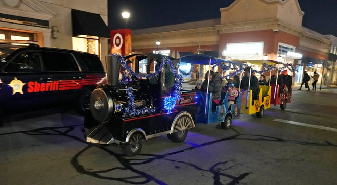 A train takes people on ride as part of a Chanukah Festival and Gelt Drop, to kick off the first day of Chanukah, in The Yard at Bayshore in Glendale on Thursday, Dec. 7, 2023. The largest Hanukkah festival in Wisconsin, hosted by Lubavitch of Wisconsin, included live music, a giant Menorah lighting, and a mega gelt and gift drop.