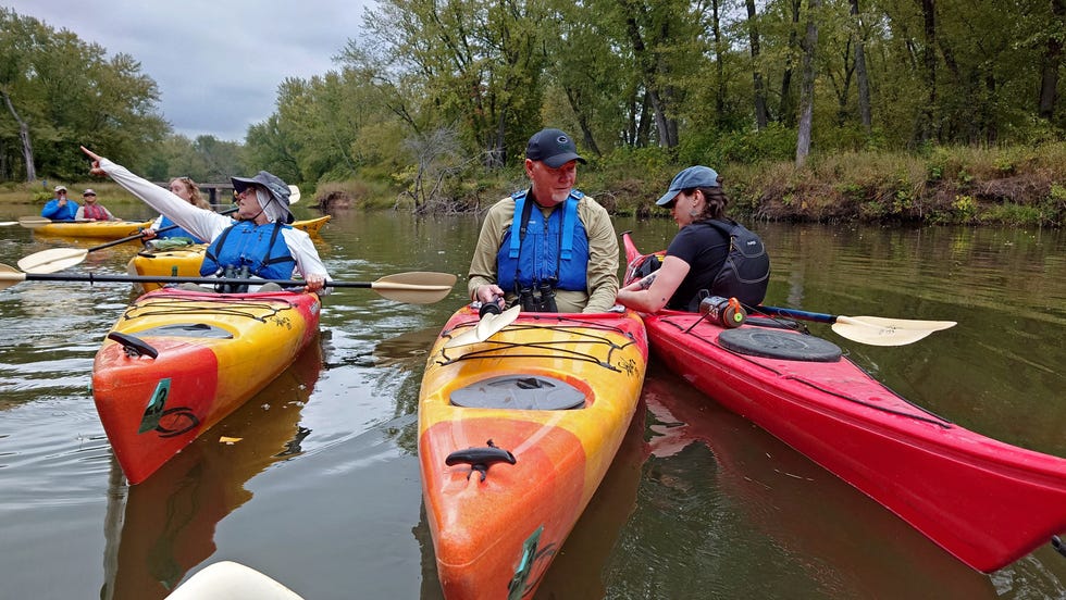 Broken Paddle Guiding Co., guide Isabel McNally, right, helps a client during a paddling trip on a tributary of the Mississippi River on Sept. 22 near Nelson, Wisconsin. McNally says it's "one of the great joys" of her job to be able to connect people to the Mississippi River.