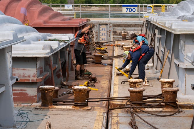 Crew from the tug Theresa L. Wood reconnect barges after locking through Wednesday, May 17, 2023 at Lock and Dam #8 in Genoa, Wis.  The vessel was moving barges from St. Louis to Winona, Minn. The locks allow the boats to gradually adjust to changing river levels. Most towboats can push 15 barges at a time on the river. When those barges reach a 600-foot long lock, they don’t fit. Instead, they have to be split up, which takes more than twice as long.It was constructed and was put into operation by April 1937.